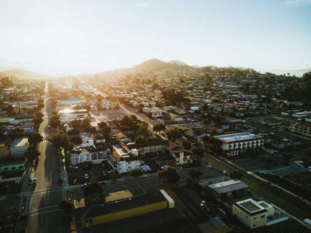 This image of a suburban cityscape at sunrise is perfect for showcasing peaceful urban living, morning routines, real estate promotions, or urban development. The warm light highlights the vibrancy and calmness of early morning in residential areas.