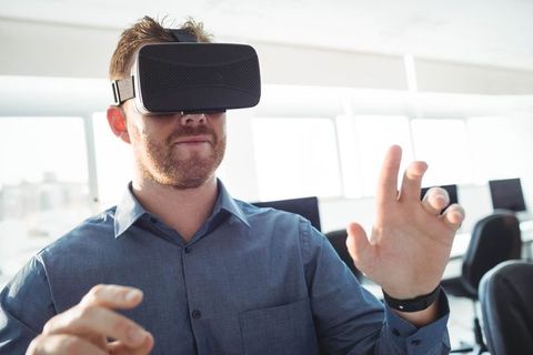Man Engaging with Virtual Reality in Modern Office
