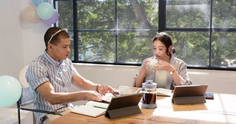 Colleagues celebrate birthday in office with coffee and cake