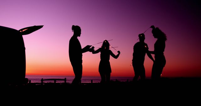 Group of Friends Enjoying Sunset with Sparklers - Download Free Stock Images Pikwizard.com