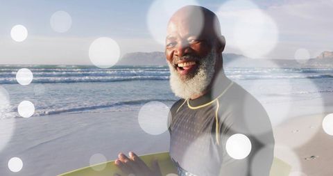 Senior Surfer Joyfully Holding Yellow Surfboard at Beach