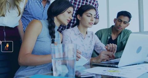 Diverse Team Collaborating Around Laptop on Business Project