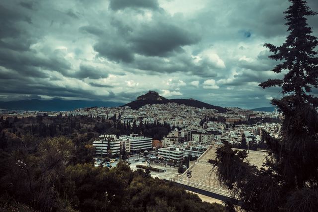 Capturing a dramatic view of Athens with Lykavittos Hill rising above the city, this image can effectively illustrate a sense of scale and contrast between urban and natural environments. Ideal for travel blogs, tourist guides, or as a backdrop for presentations about Greece, showcasing the unique blend of ancient and modern Greek architecture.