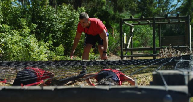 Coach Training Children on Obstacle Course in Forest - Download Free Stock Images Pikwizard.com