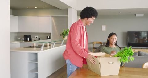 Couple Unpacking Fresh Produce in Modern Home Kitchen