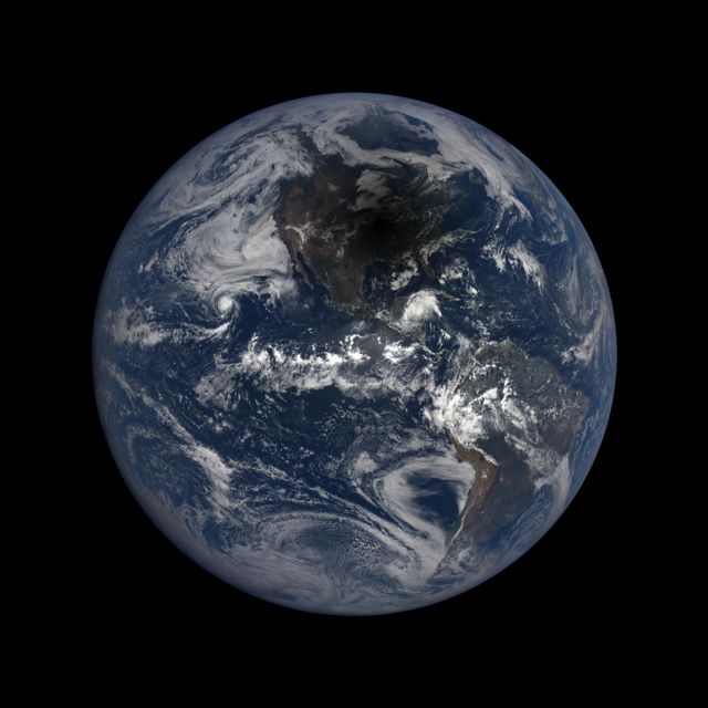 A breathtaking view of Earth captured by NASA's DSCOVR satellite on August 21, 2017, showing the moon's shadow crossing over North America during a total solar eclipse. Perfect for educational materials, science articles, and space-related projects.
