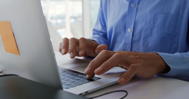 Focused Professional Typing on Laptop in Modern Office - Download Free Stock Images Pikwizard.com