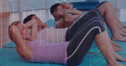 Group doing crunches on mats with tech data overlay fitness class concept for wellbeing