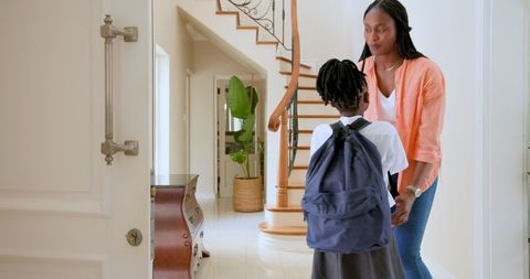 Mother Encouraging Daughter Before School Day at Home