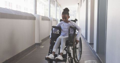 Confident Girl in Wheelchair Navigating School Hallway - Download Free Stock Images Pikwizard.com