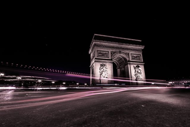 This stock photo is ideal for illustrating urban nightlife, Parisian landmarks, and travel themes. Use it in blogs, travel guides, or cityscape galleries. The dynamic light trails add a modern and energetic touch to classic architecture.