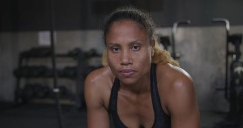 Determined Athlete Resting in a Gym Environment