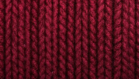 Burgundy ribbed knit showing thick plied yarn and detailed fibers macro texture