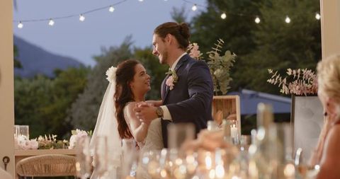 Bride and Groom Dancing at Romantic Outdoor Evening Wedding
