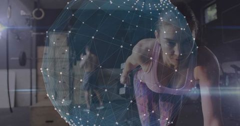 Female athlete performing plank row with dumbbell while augmented reality data sphere overlays gym