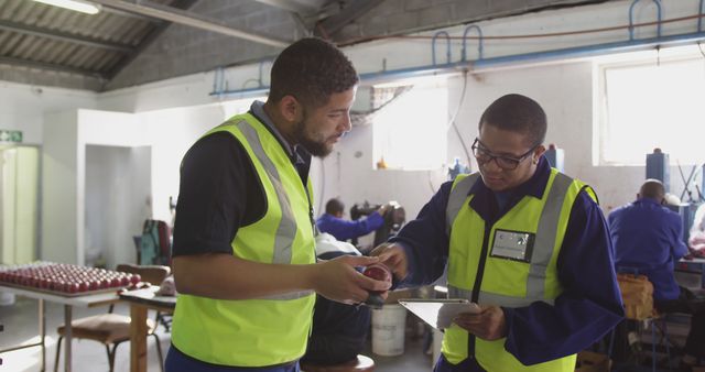 Two Factory Workers in High Visibility Jackets Talking - Download Free Stock Images Pikwizard.com