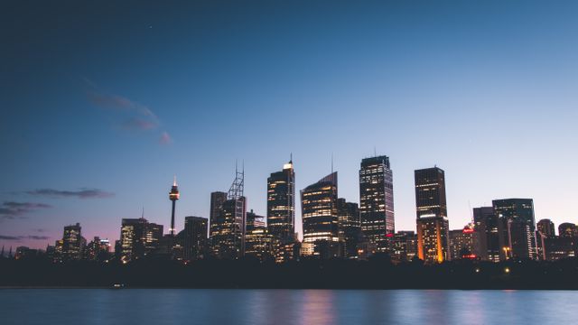 Perfect for use in travel brochures, websites promoting Sydney, or presentations needing visuals of urban landscapes. Highlights the architectural beauty and vibrant energy of Sydney at twilight.