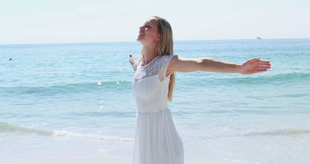 Woman in White Dress Enjoying Sea Breeze on Sunny Beach Day - Download Free Stock Images Pikwizard.com