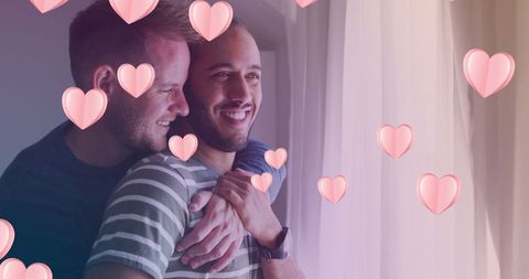 Diverse Gay Couple Embracing with Romantic Heart Overlay