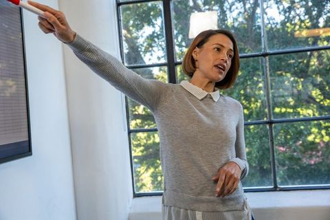 Senior woman leading presentation in bright meeting room