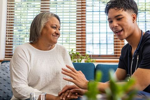 Caregiver Providing Support to Senior Woman at Comfortable Home