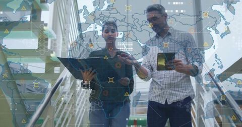 Colleagues analyzing data on staircase with world map overlay