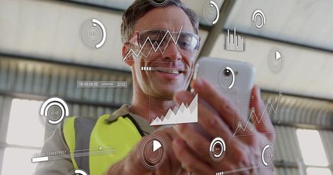 Engineer using mobile technology in manufacturing facility