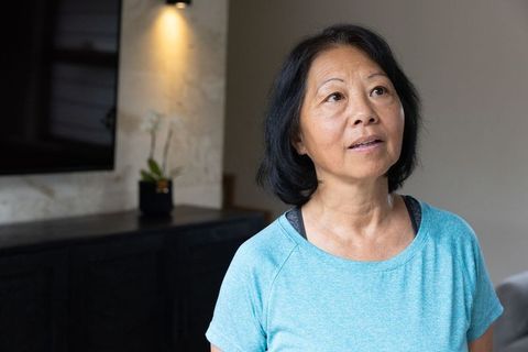Senior Woman in Activewear Gazing Upward Indoors