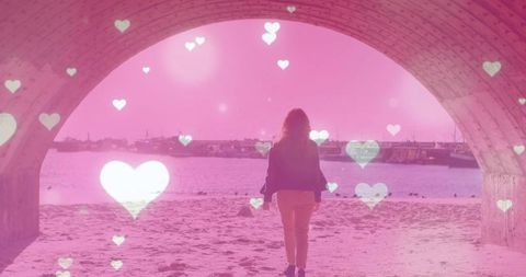 Romantic walk through archway towards sandy beach