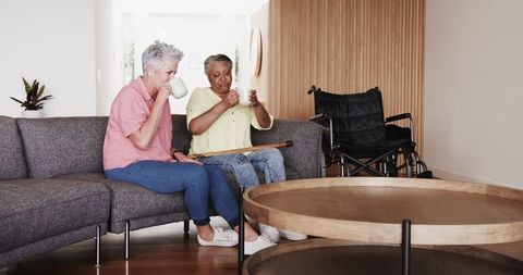 Happy Senior Couple Relaxing with Coffee on Living Room Couch