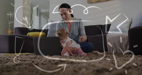Mother guiding baby at laptop on cozy living room rug, remote work and bonding, parenting