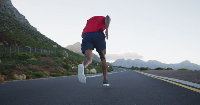 Rear view of african american man running on the road - Download Free Stock Photos Pikwizard.com