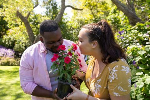 Couple Enjoying Sweet Aroma of Vibrant Garden Blossoms