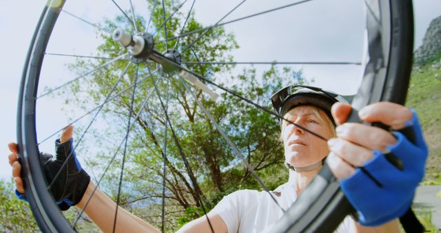 Cyclist Fixing Bicycle Wheel Outdoors - Download Free Stock Images Pikwizard.com