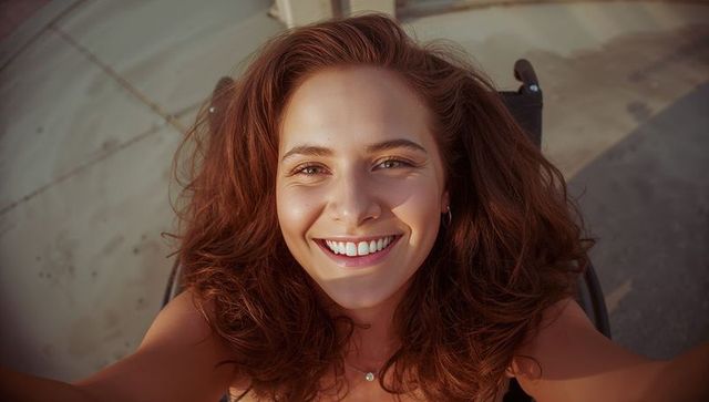 Smiling Woman in Wheelchair Taking Selfie on Sunny Day