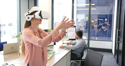 Businesswoman Engaging with VR Technology in Modern Office Environment