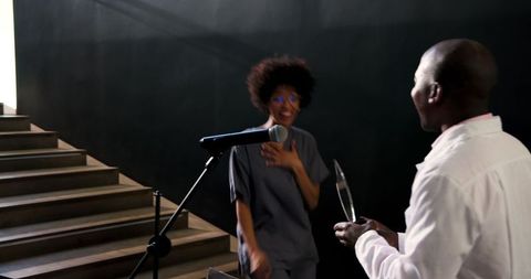 Happy colleague receives award from smiling doctor