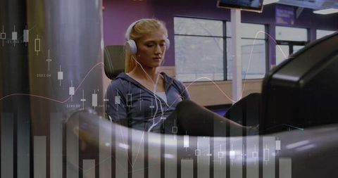 Young woman exercising on recumbent leg press wearing headphones with data charts overlay