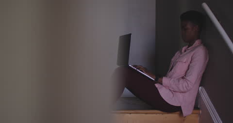 Woman Working from Home on Stairs with Laptop