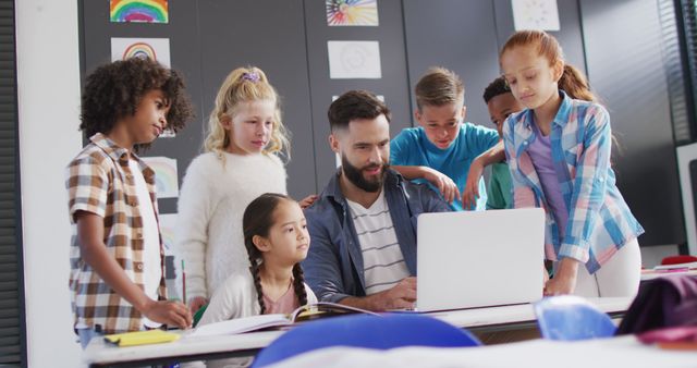 Teacher Using Laptop with Diverse Group of Engaged Students in Classroom - Download Free Stock Images Pikwizard.com