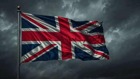British empire flag fluttering proudly against ominous storm clouds