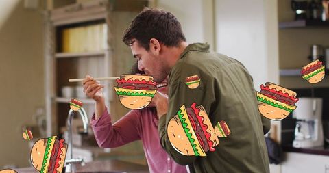 Couple Tasting in Kitchen with Fun Falling Burger Icons - Download Free Stock Images Pikwizard.com