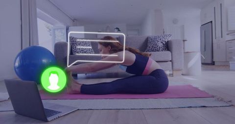 Woman practicing yoga at home using online fitness program