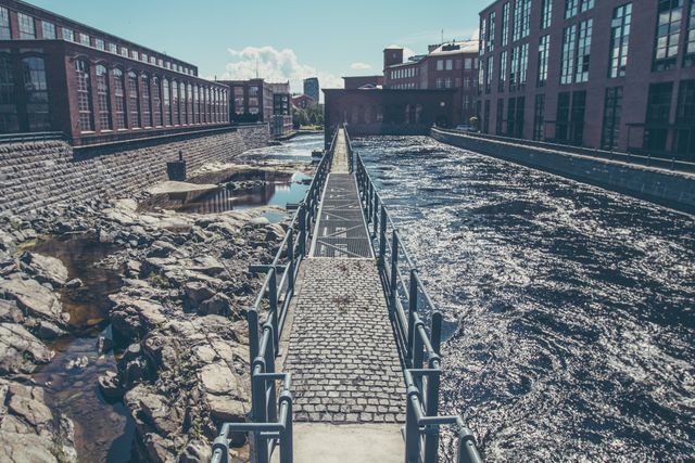 Historic Industrial Waterway with Cobblestone Path and Brick Buildings - Download Free Stock Images Pikwizard.com