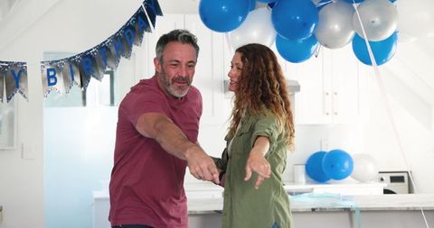 Happy Couple Celebrating Birthday at Home with Decorations