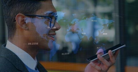 Businessman speaking into smartphone with global data overlay in modern atrium