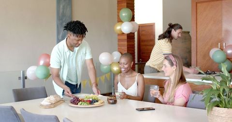 Celebrate with Friends at Home, Enjoying Drinks and Lively Conversation