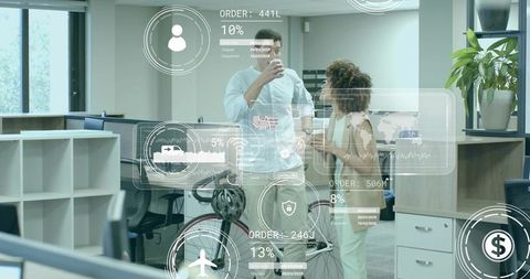 Co-workers engaged with digital interface in tech-centric office environment