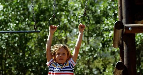 Boy Enjoying Playground Adventure on Sunny Day