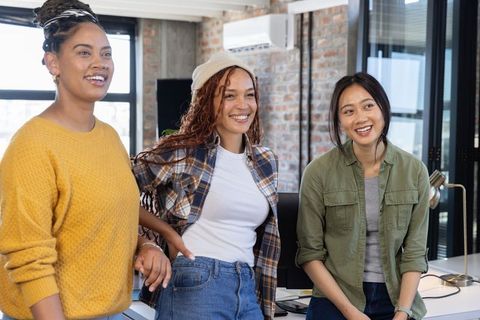 Happy Team of Women Collaborating in Modern Office